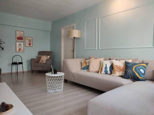 a living room with a couch and a chair at Stylish Spacious 3B Flat in Ortaköy near Bosphorus in Istanbul
