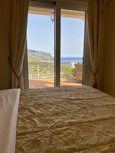 a bedroom with a bed and a view of the ocean at Casa Del Mar in Ponta do Sol