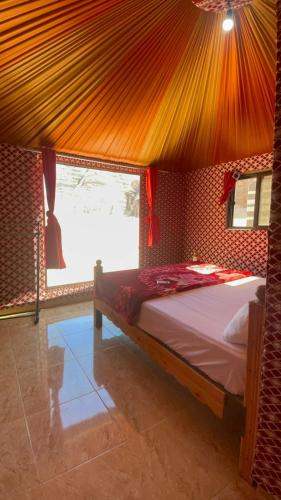 a bedroom with a bed in a tent at غرووب وادي رم in Wadi Rum