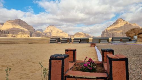 a view of the wadi rum desert with mountains in the background at Qais Camp Wadi Rum in Wadi Rum