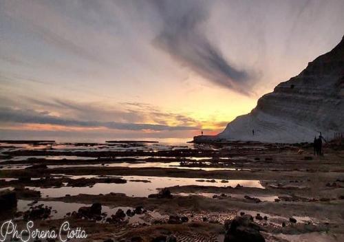 a person standing on the beach at sunset at Casa Villaggio Pirandello in Agrigento