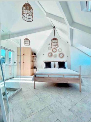 a bedroom with a bed in a room at The View, Kingsand, luxurious seafront penthouse apartment with sun trap balcony and incredible sea views in Kingsand