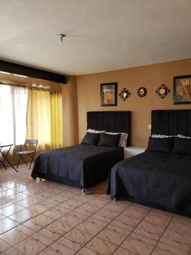 a bedroom with two beds in a room at Casa Gracia in Jamay