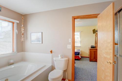 a bathroom with a tub and a toilet and a sink at Gray Haven #11-DE in Avon