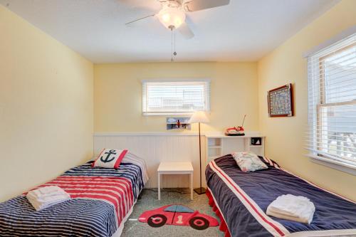 a bedroom with two beds and a toy car on the floor at Gray Haven #11-DE in Avon