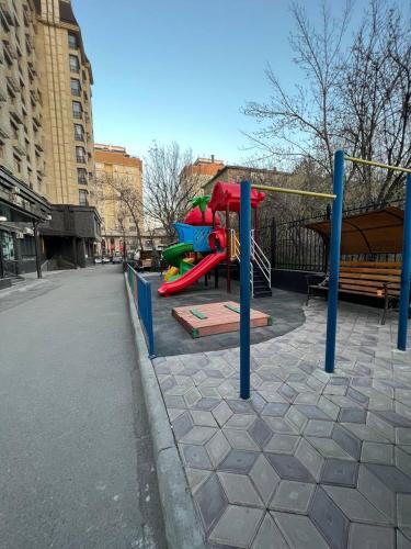 a playground with a slide in a city at 1-room apartment Masaka in Bishkek