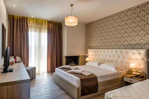 A bed or beds in a room at Lagaria Hotel
