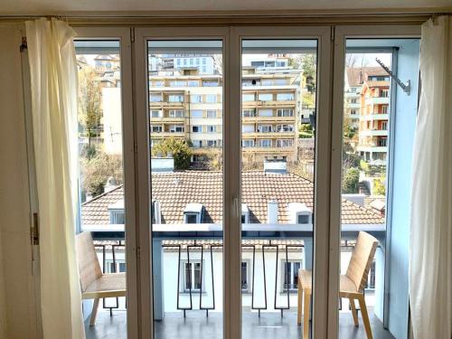 a view from a room with sliding glass doors at El Hamra - cozy - by PA in Luzern