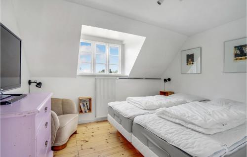a white bedroom with a large bed and a window at Awesome Home In Martofte With Wifi in Martofte