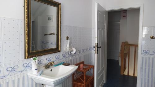 a bathroom with a sink and a mirror at Domek na wsi 