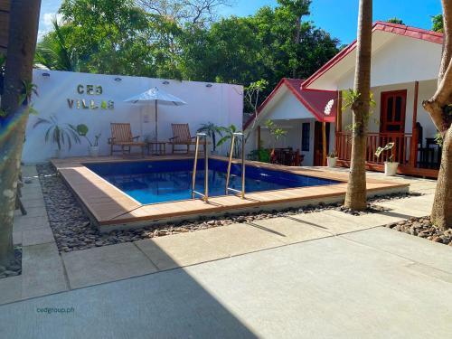 a swimming pool in front of a house at CED Villas in El Nido