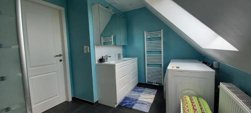 a bathroom with a sink and a washing machine at Hermelgemhoeve - Liriope in Zwalm
