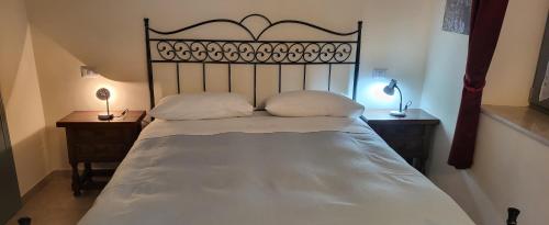 a bedroom with a large bed with two night stands at Apartment Nonna Delia in Guardea