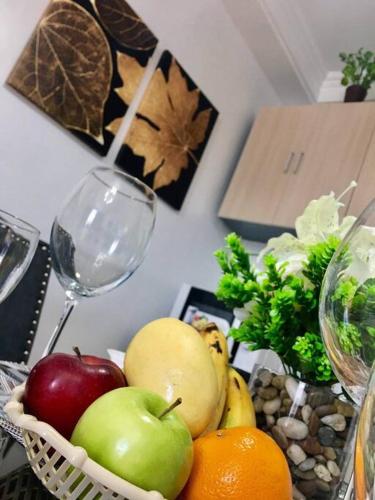 a bunch of fruits and vegetables on a table with wine glasses at Minimalist studio with Luxury bed Good for 1-4pax High speed WiFi with Netflix Free Pool & Parking in Suba