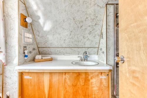 a bathroom with a sink and a marble wall at Chalet Shangri-La in Welches