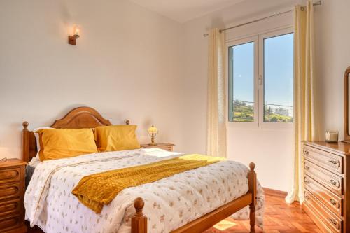 a bedroom with a large bed and a window at Casa do Valentim, a Home in Madeira in Ponta do Sol