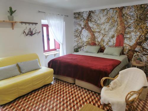 a bedroom with two beds and a couch in it at 4Bs - Birds & Bicycles in Castro Verde