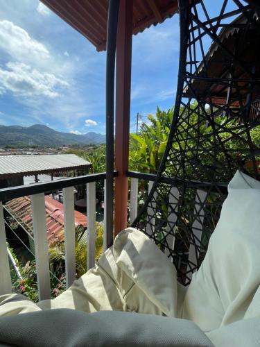 a room with a bed and a balcony with a view at Dreams Lodge Orosi in Cartago