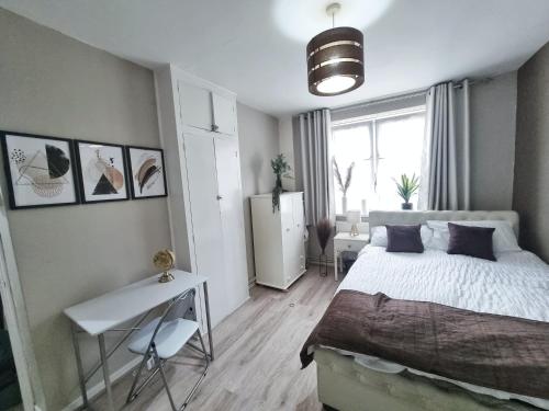 1 dormitorio con cama y escritorio. en The Headlam Apartment en Londres