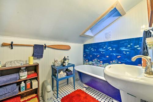 a bathroom with a large fish tank on the wall at Cozy Catskills Vacation Rental with Deck! in Fleischmanns