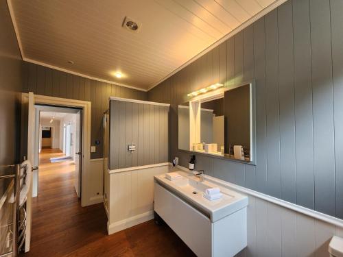 a bathroom with a sink and a mirror at Hot Water Beach Escape in Hotwater Beach