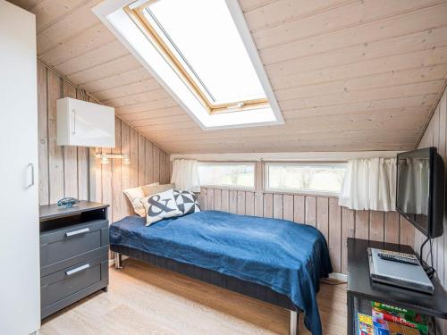 um quarto com uma cama e uma clarabóia em Holiday home Hemmet CXCIII em Hemmet