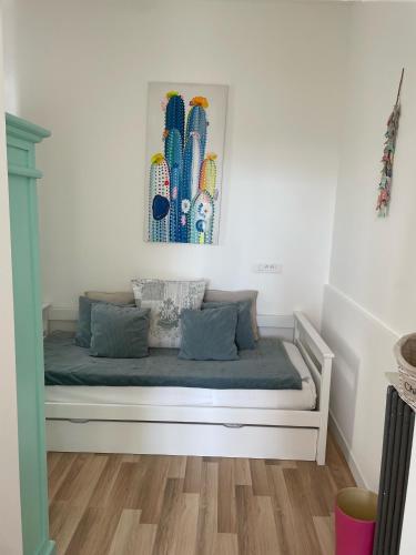 a white bed in a room with a picture on the wall at Hôtel La Villa Patricia - Charme et Tradition in Villefranche-sur-Mer