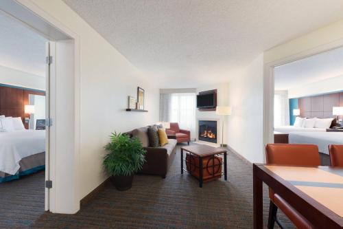 a hotel room with two beds and a living room at Residence Inn by Marriott Oklahoma City Downtown/Bricktown in Oklahoma City