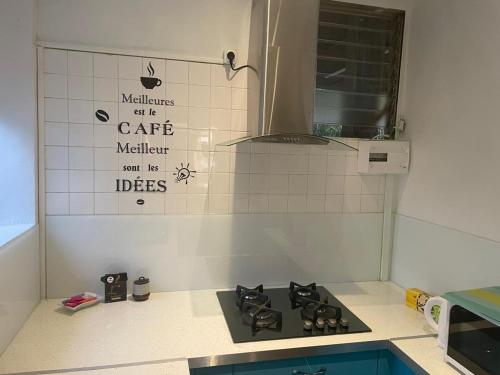 a kitchen with a stove top in a kitchen at La résidence du sportif Bernard in Anse-Bertrand