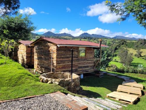 a log cabin with a view of the mountains at El Refugio del Santo 
