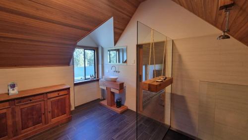 a bathroom with a sink and a mirror at The Stables - Farm Stay in Strath Creek