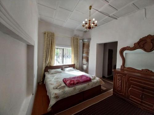 um quarto com uma cama grande e uma janela em Fayz Guest House em Samarkand