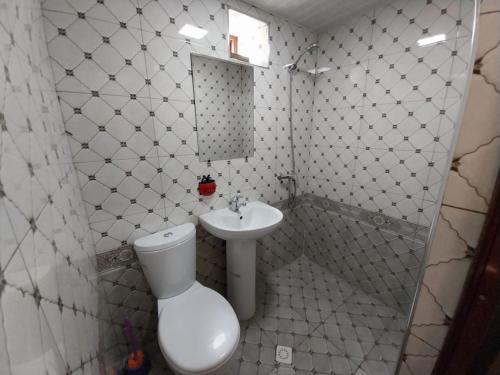 a bathroom with a toilet and a sink at Fayz Guest House in Samarkand