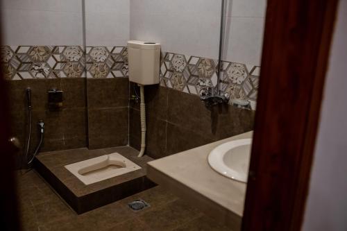 a bathroom with a sink and a toilet at Regal Residency in Rawalpindi