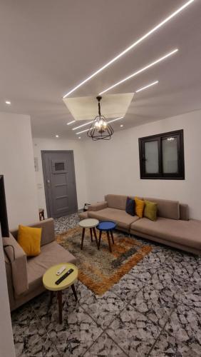 a living room with a couch and a table at Alex Gate apartment - families only in Alexandria