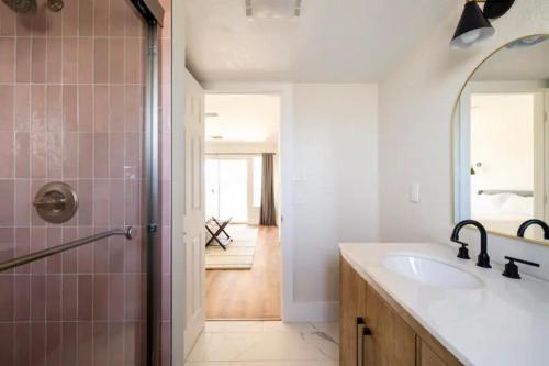 a bathroom with a sink and a shower with a mirror at Heated Pool and Jacuzzi, Scenic Mountain View, Lux and Cozy, in Cottonwood
