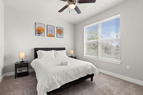 a bedroom with a bed and a ceiling fan at The Ladybird: Riverwalk Loft in San Antonio