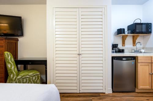 a closet in a kitchen with a table and a chair at The Inn on Pine in Calistoga