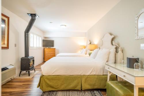 a bedroom with a large bed and a stove at The Inn on Pine in Calistoga