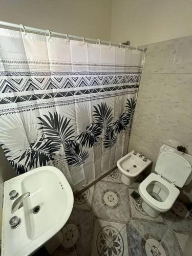 a bathroom with a toilet and a bidet and a sink at Magnolia II Departamento Céntrico in San Fernando del Valle de Catamarca