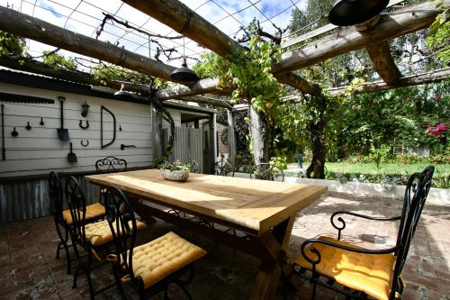 a wooden table and chairs on a patio at Rústicoq B+B in Cowaramup