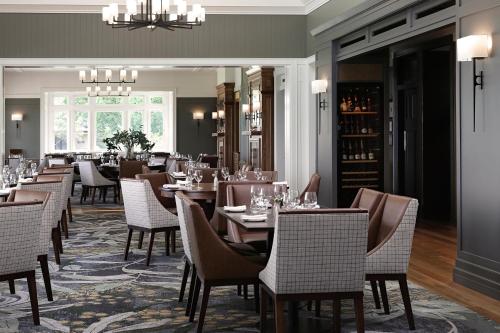 a restaurant with tables and chairs and a chandelier at Spicers Hidden Vale in Grandchester
