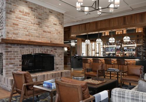 a lobby with a fireplace and a bar at Spicers Hidden Vale in Grandchester