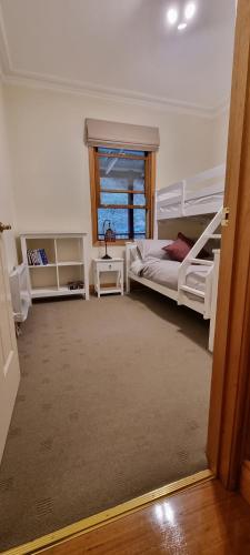 a bedroom with two bunk beds and a window at Whitlow Manor in Walhalla