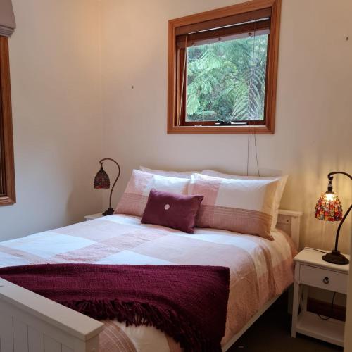 a bedroom with a bed with two lamps and a window at Whitlow Manor in Walhalla