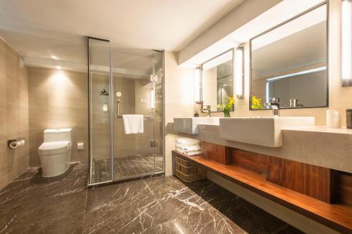 a bathroom with a sink and a shower at SSAW Boutique Hotel Shanghai Huangpu River in Shanghai