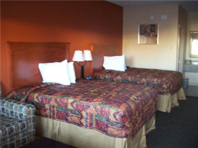 a hotel room with two beds and two lamps at Budgetel Inn and Suites in Hearne