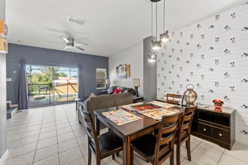 a dining room and living room with a table and chairs at *PRIVATE POOL* Disney10min - Magical Mickey themed home in Kissimmee