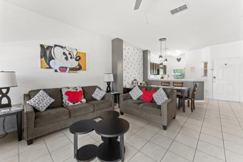 a living room with a couch and a dining room at *PRIVATE POOL* Disney10min - Magical Mickey themed home in Kissimmee