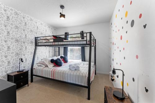 a bedroom with a bunk bed and a rock wall at *PRIVATE POOL* Disney10min - Magical Mickey themed home in Kissimmee